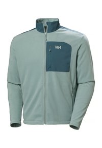 Chaqueta de forro polar azul claro con cuello alto, cremallera frontal y un bolsillo en el pecho de color teal con un logo. Tejido transpirable con textura suave.