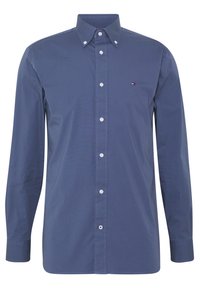 Camicia blu a maniche lunghe con colletto classico, bottoni bianchi e un piccolo logo sul petto sinistro. Tessuto di cotone liscio.