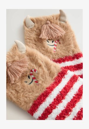 Fuzzy brown mittens feature cream horns, a smiling face with a candy cane, and red and white striped cuffs. Soft texture and playful design.