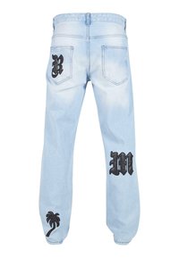 Light blue denim jeans with a relaxed fit. Black embroidered letters “B” and “M” on the back pockets, and a palm tree design on the left leg.