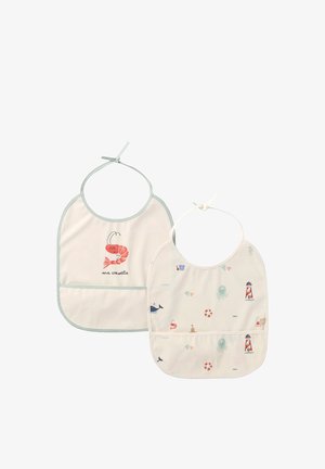 Two cream-colored baby bibs with sea-themed prints; one has a smiling shrimp and "ma crevette" text, the other has lighthouses and marine creatures.