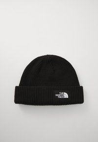 Black knit beanie with a ribbed texture and a folded cuff. Features a rectangular white logo patch with "THE NORTH FACE" branding.