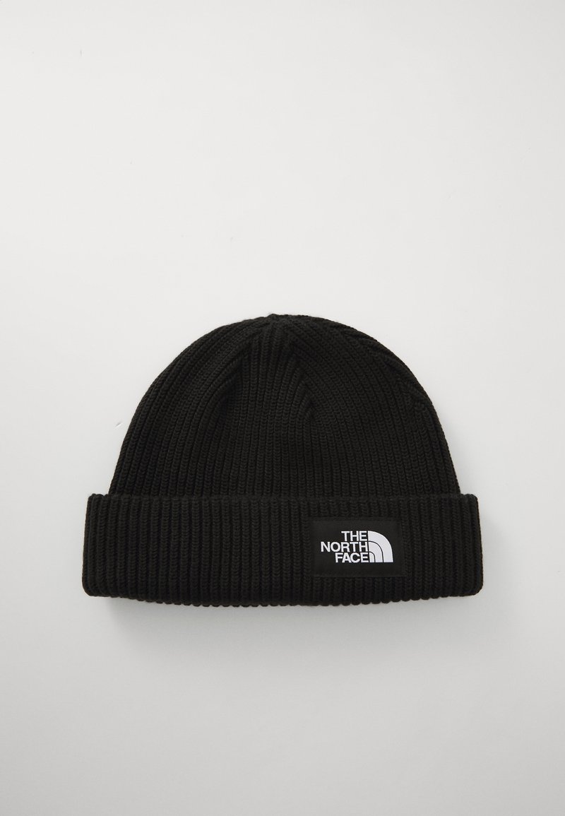 Black knit beanie with a ribbed texture and a folded cuff. Features a rectangular white logo patch with "THE NORTH FACE" branding.