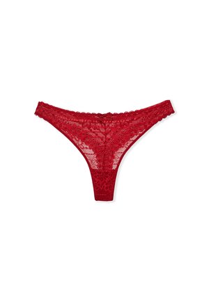 Red lace thong featuring floral patterns, scalloped edges, and a satin bow detail at the front, made from soft, sheer material.