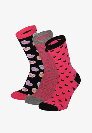 Drei bunte Crew-Socken mit herzförmigen Mustern: eine schwarze mit Zuckerherzen, eine rosa-grau gestreifte und eine rosa mit schwarzen Herzen.