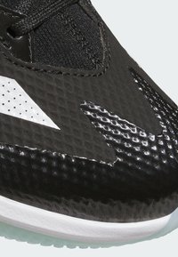 Black athletic shoe featuring a textured synthetic upper, gloss black accents, white logo, and a light gray rubber outsole.