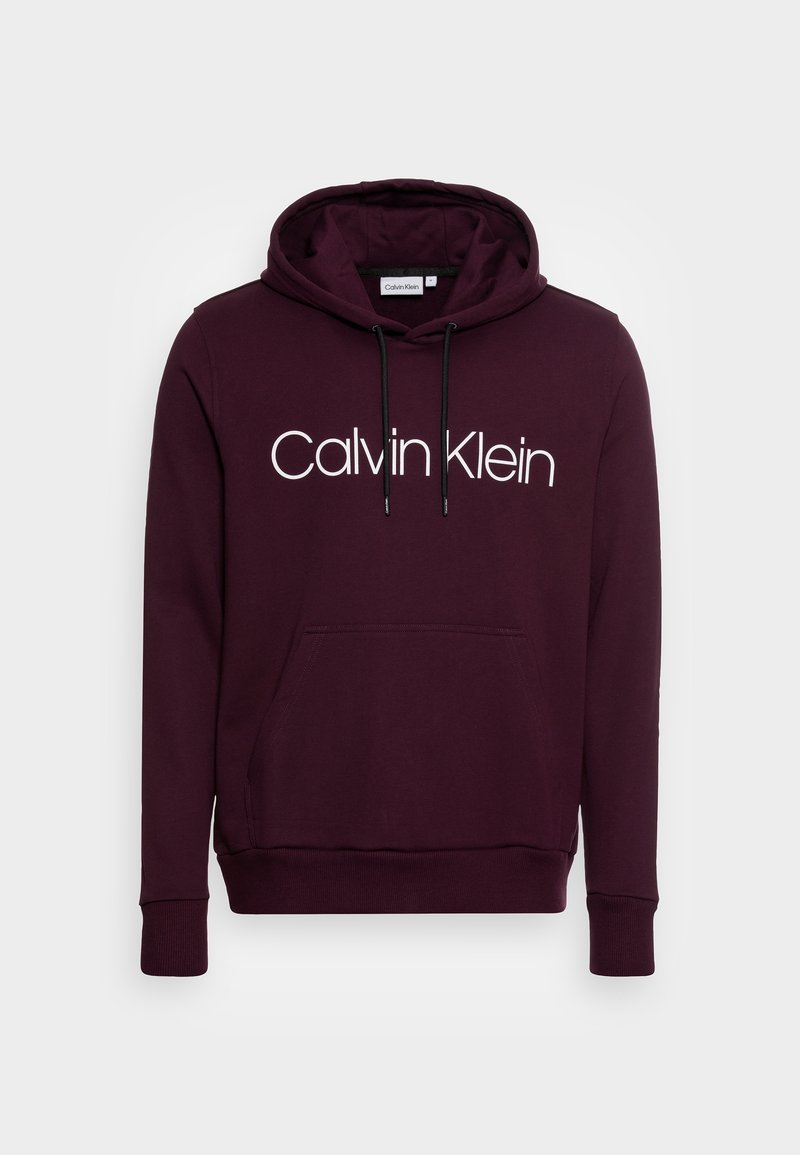 Bordový svetr s kapucí a stahovací šňůrkou, přední kapsou, elastickými manžetami a velkým bílým logem "Calvin Klein" na hrudi. Měkká tkanina.