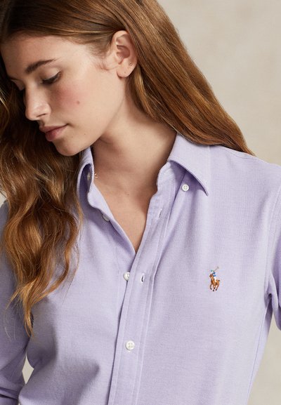 Light purple cotton button-up shirt with a textured fabric, featuring a small embroidered logo of a horse and rider on the left chest.