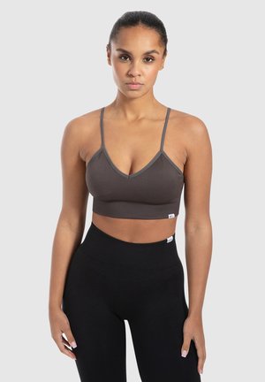 Braun gerippter Bralette mit dünnen verstellbaren Trägern, V-Ausschnitt und einem Saum, der über der Taille sitzt. Enthält ein kleines Logotag.
