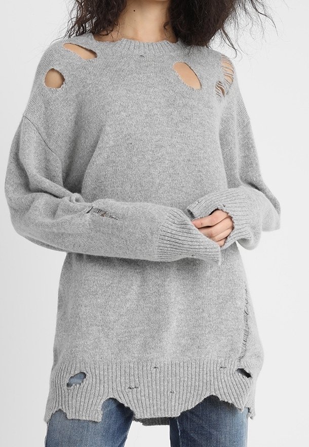 Grauer Strickpullover mit großen Ausschnitten, gerippten Bündchen und einem ausgefransten Saum. Hat eine lockere Passform und eine weiche Textur.