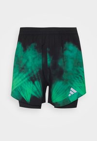Svarta och gröna tie-dye träningsshorts med elastisk midja. Har ljusgröna mönster som strålar ut från mitten och en liten logotyp.