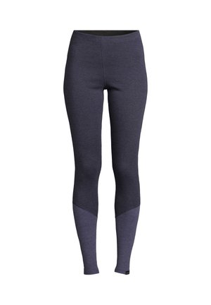 Marineblauwe leggings met een aansluitend ontwerp. Ze hebben een effen bovenstuk en een contrasterend lichtpaarse strook aan de onderbenen.