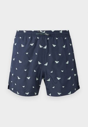 Short de bain bleu marine avec motif de logo blanc, taille élastique avec cordon de serrage et fentes latérales sur les jambes.