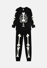 Ensemble de pyjama noir à manches longues avec imprimé de squelette blanc, présentant un design de cage thoracique sur le haut et des motifs d'os sur le pantalon. Matériau en coton.