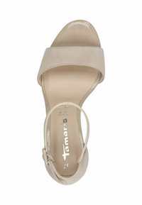 Beige high-heeled sandal featuring a wide suede strap and a glossy toe cap. An ankle strap secures with a delicate buckle.