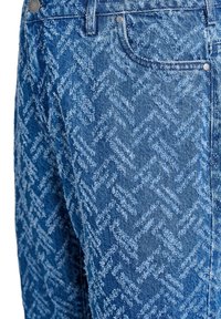 Blue jeans featuring a textured herringbone pattern, made of denim, with contrasting shades of blue, and metal hardware accents.