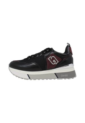 Sneaker in pelle nera e mesh con dettagli bordeaux, logo argento sul lato, suola spessa bianca e grigia e lacci neri.