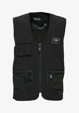 Gilet nero con scollatura a V, inserto in tessuto a rete, due tasche anteriori con zip e etichetta a toppa. Presenta un ulteriore taschino superiore.