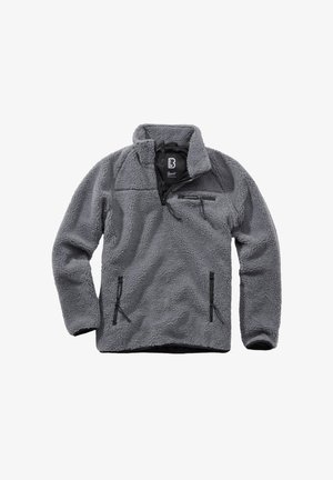 Pilkas fliso megztinis su ketvirčio užtrauktuku, aukštu apykakliu, krūtinės kišene užtrauktuku ir dviem kišenėmis rankoms su užtrauktukais, pagamintas iš storos tekstūruotos medžiagos.