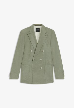 Grüner doppelt knöpfbarer Blazer aus strukturiertem Stoff, mit zwei Fronttaschen und subtilen Schulterpolstern. Besondere Merkmale sind die silbernen Knopfakzente.