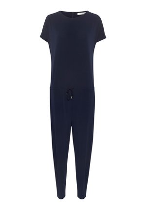 Tengerészkék overál rövid ujjakkal, kerek nyakkivágással, zsinórral szabályozható derékkal és két elülső zsebből áll. Sima anyag, ellazult szabással.