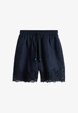 Tumesinised elastse vöökohaga lühikesed püksid, millel on nöörpael, peen lillemustriga tikand ja keeruka pitsäärega alumises servas.