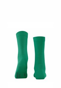 Calze di cotone verdi con bordo a coste e una texture liscia, con un logo ricamato sul lato. Design di lunghezza a metà polpaccio.