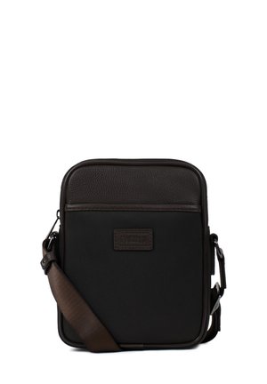 Petit sac bandoulière noir avec garniture en cuir marron foncé et bandoulière réglable, conçu pour un usage quotidien.