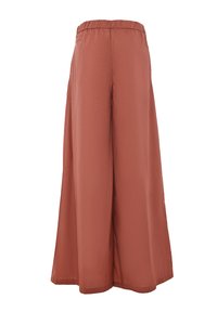 Wide-leg pants in a rust color, made from lightweight fabric. Features an elastic waistband and a smooth, flowing texture.