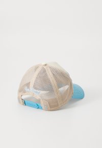 Baseball cap with a light beige mesh back, blue visor, and back strap. Features an embroidered detail in light blue on the back.