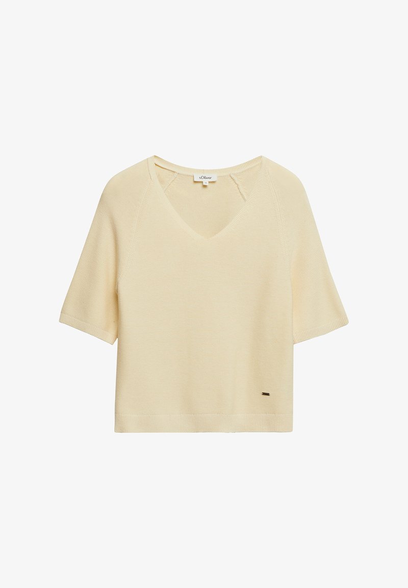 Haut en maille beige clair à manches courtes avec col en V et petite étiquette de marque près de l'ourlet, présenté sur fond blanc.