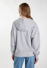 Grauer Baumwollhoodie mit großer Kapuze, überschnittenen Schultern und gerippten Bündchen. Verfügt über einen lässigen Schnitt und ein einfaches Design.