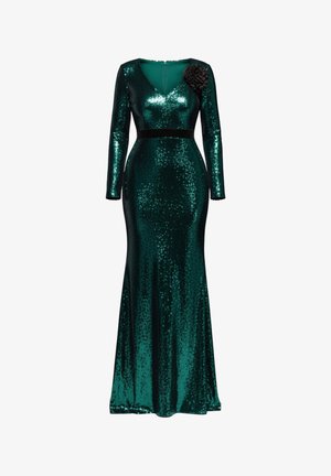 Langarmige, donkergroene jurk met pailletten en een nauwsluitend silhouet, met een V-hals en een zwart bloemaccent op de schouder.
