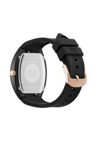 Juodas gumos laikrodžio dirželis su aukso spalvos metalo sagtimi. Stačiakampis sidabro nerūdijančio plieno korpusas, išgraviruotas "ice watch."