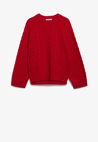 Raudonas megztinis su pynių raštu, su raukinėta apykakle ir rankogaliais, bei laisvu siluetu. Su trumpu kraštu ir raglano rankovėmis.