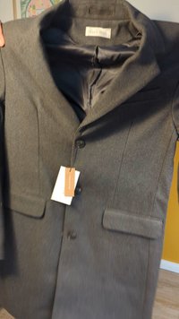 Gray wool blazer with a smooth inner lining, single button closure, two front pockets, and a hang tag attached.
