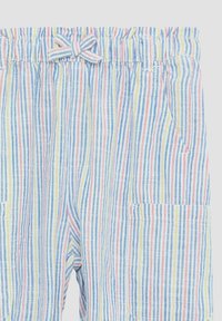 Gestreifte Hosen mit elastischem Bund und Schleifendetail. Farben sind Gelb, Blau und Rot. Verfügt über zwei Seitentaschen. Strukturierter Stoff.