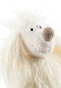 White plush toy with long, fuzzy hair; round head features large eyes and a beige nose; soft texture and simple facial detailing.