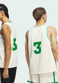 White basketball jersey featuring a textured mesh design, green accents, and a large green number 3 on the back.