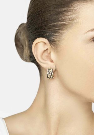 Gold and black earrings with a twisted design, featuring sparkling accents. The ear design is small and close-fitting against the earlobe.