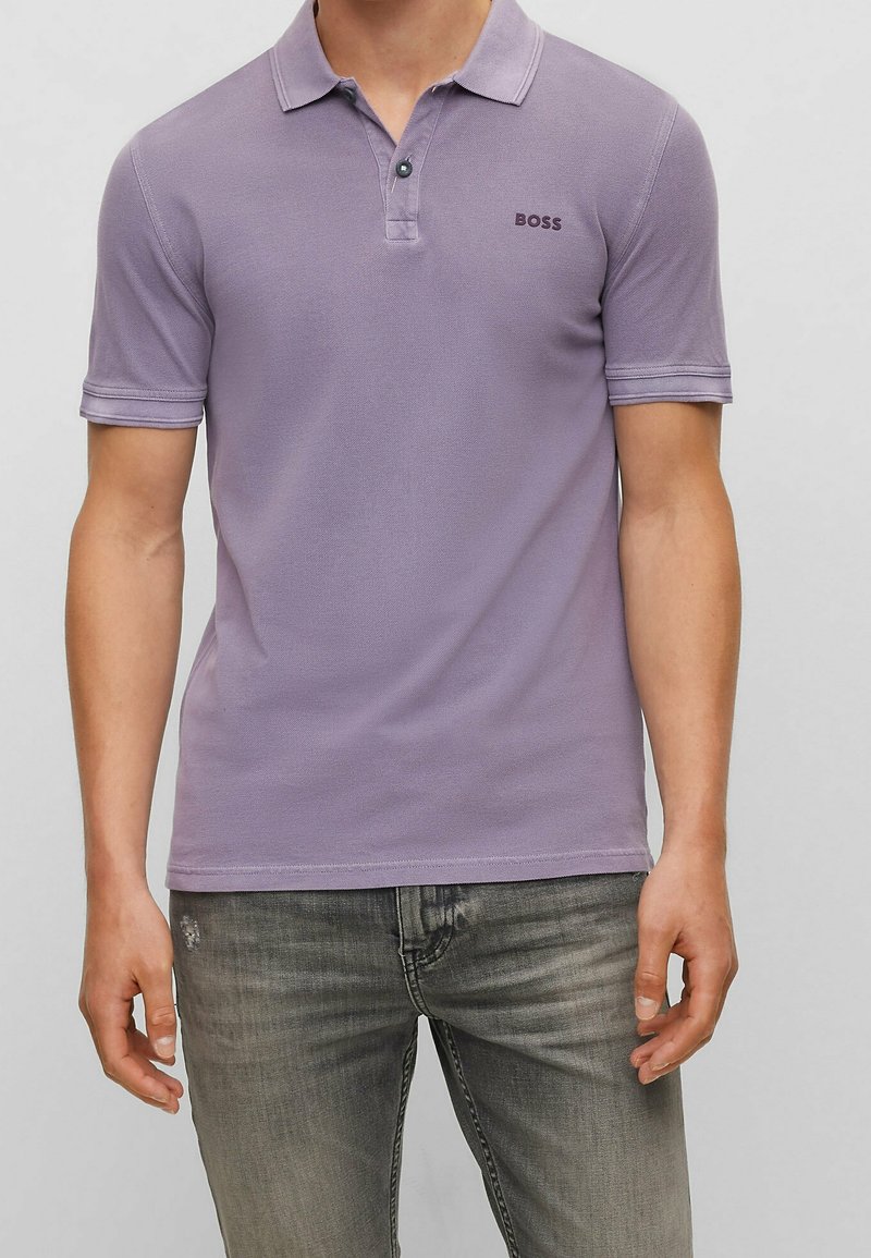 Polo viola in cotone strutturato, con patta con bottoni, maniche corte e piccolo logo "BOSS" sul petto.