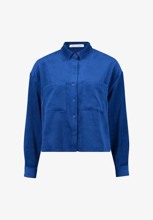 Blå kordfløjl skjorte med knapper og krave, to brystlommer og lange ærmer. Ribbet tekstur og løstsiddende design.