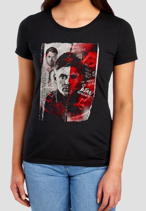 Black t-shirt with a split portrait of three men, red accents, and text including "Supernatural" and "The Mark of Cain."
