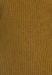 Ribbed knit fabric in deep mustard yellow, which features a textured surface with vertical lines, creating a fitted appearance.
