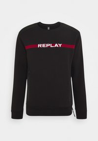 Felpa nera in cotone con colletto rotondo. Presenta il logo rosso e bianco "REPLAY" sul petto e tasche laterali con zip.