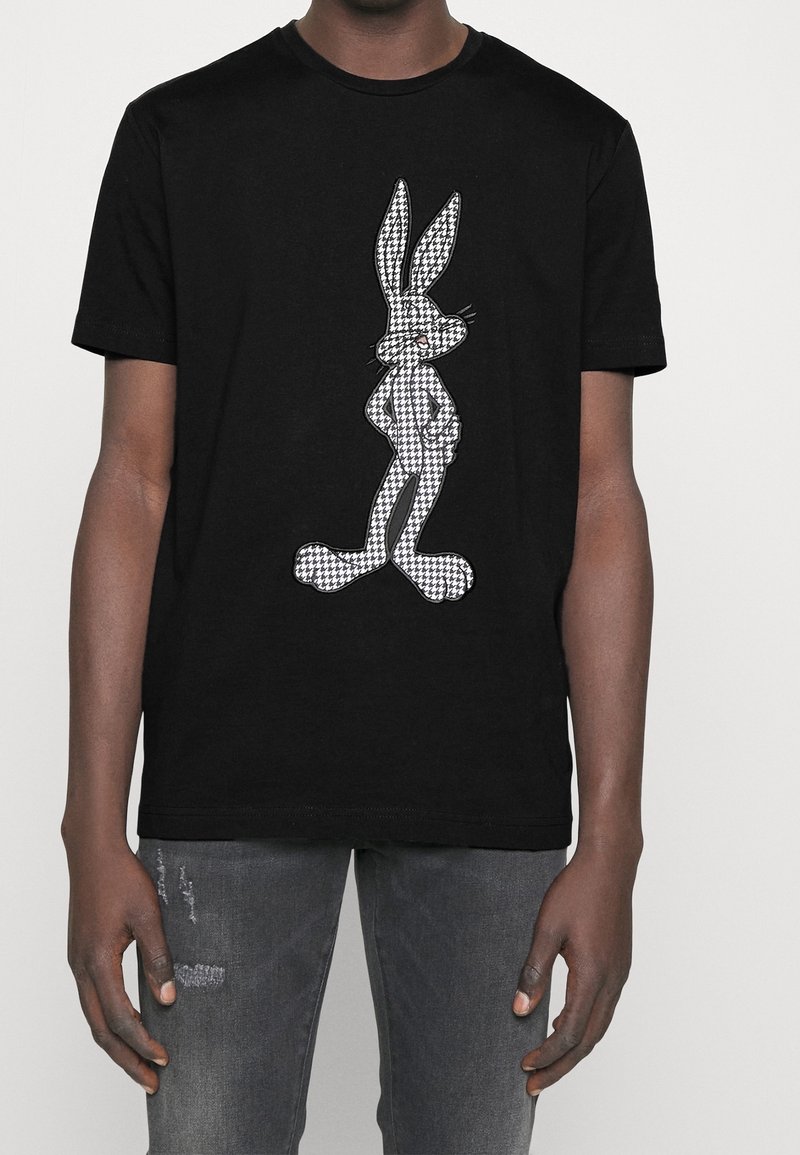 Black cotton t-shirt featuring a white houndstooth pattern of a rabbit graphic, short sleeves, and a classic crew neckline.