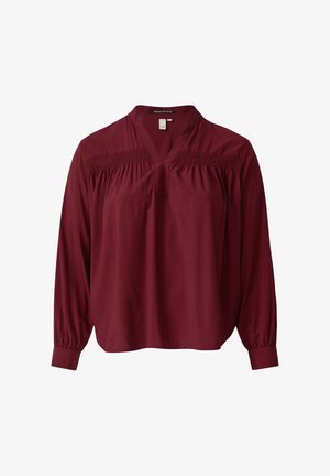 Blusa bordeaux a maniche lunghe con scollo a V e dettagli arricciati sulle spalle, realizzata in un tessuto morbido con polsini leggermente elastici.