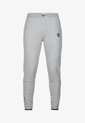 Grå sweatpants med slim fit, der har to sidelommer, en elastisk talje med snøre og et sort logo på venstre lår.