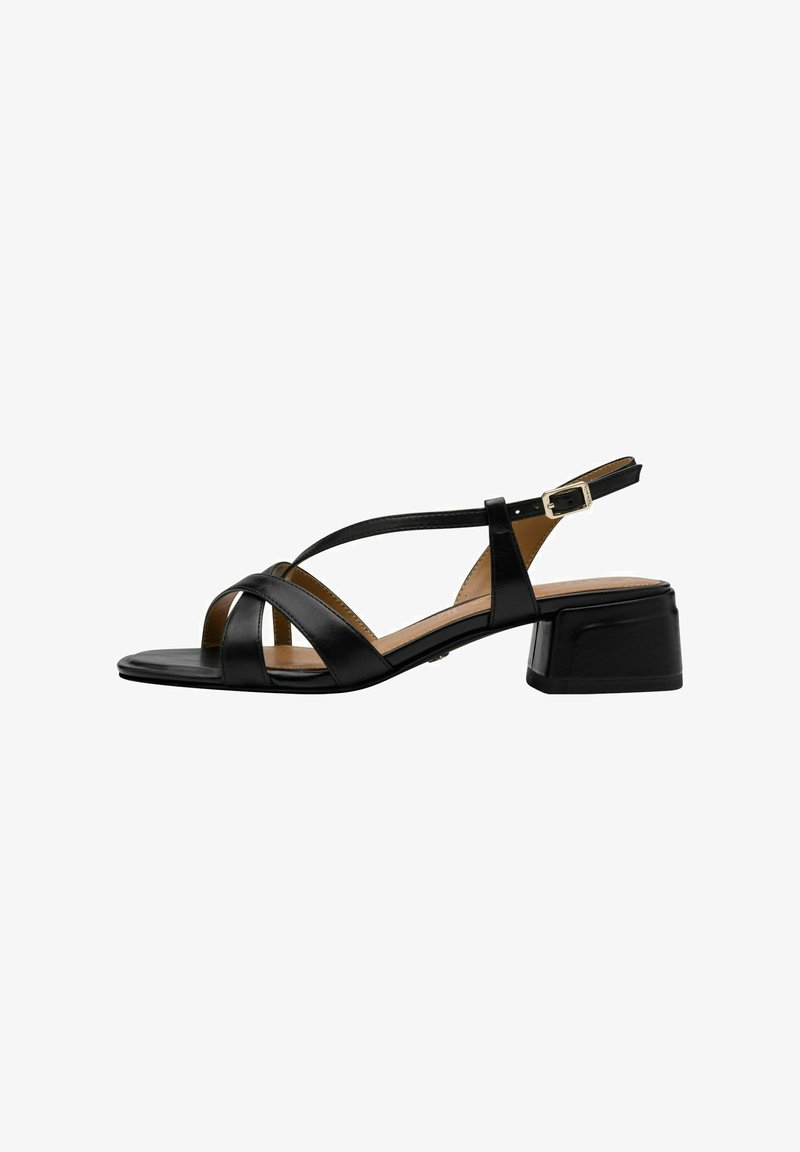 Black leather sandal with cross straps and a square toe. Features a low block heel and an adjustable ankle strap with a metal buckle.