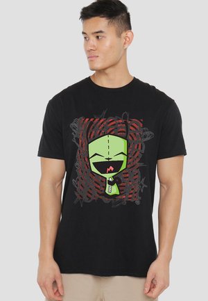 Black cotton t-shirt featuring a colorful graphic of a green character with a wide smile, set against red and black abstract patterns.